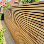 4x4 beams or slatted ipe timber fence with epdm foil installed behind it